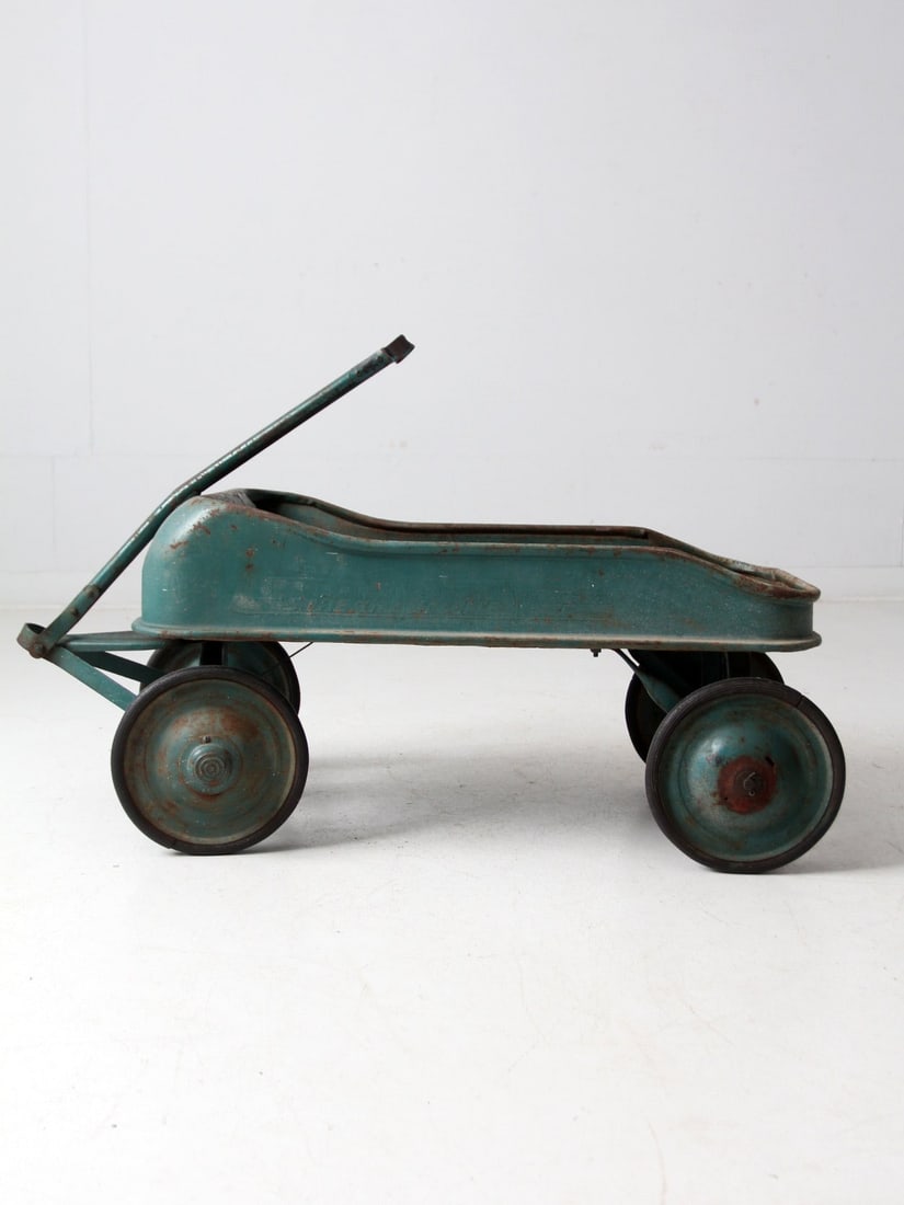 Antique Garton Streak O Lite Metal Toy Wagon Teal Green 41.5 Inch: Antique Garton Streak O Lite Metal Toy Wagon Teal Green 41.5 Inch This antique "Streak O Lite" pressed steel pull wagon by Garton Toy Company hails from the late 1930s to early 1940s. It features a so