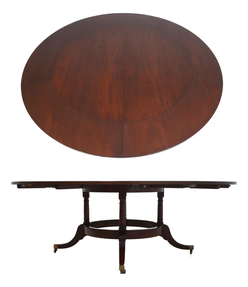 Mahogany Dining Table With Five Leaves and Brass-Capped Feet: Mahogany Dining Table With Five Leaves and Brass-Capped Feet This Regency-style dining table is crafted from mahogany and features a rich, high-sheen finish. It is designed with a circular pedestal ba