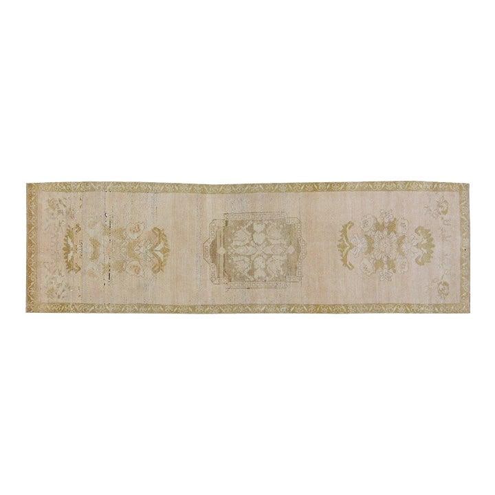 Hand-Knotted Wool Oushak Runner Rug in Camel 3'x10'2": Hand-Knotted Wool Oushak Runner Rug in Camel 3'x10'2" This vintage Turkish Oushak rug is hand-knotted from wool using traditional techniques, offering a blend of classic artistry and modern design. It