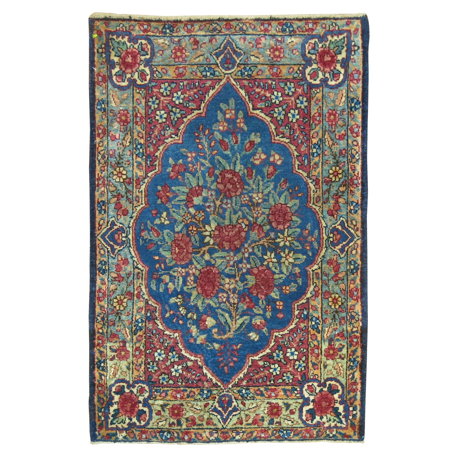 Vintage 1920s Wool Kirman Blue Persian Mini Rug: Vintage 1920s Wool Kirman Blue Persian Mini Rug Discover the exquisite beauty of this traditional Kerman mat mini rug, meticulously hand-woven from high-quality wool. Originating from Iran in the 1920