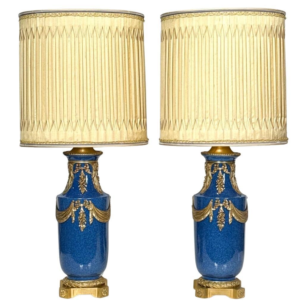 Set of Two Louis XVI French Blue Porcelain Lamps with Gilt Bronze Mounts: Set of Two Louis XVI French Blue Porcelain Lamps with Gilt Bronze Mounts This pair of late 19th century French table lamps features porcelain vases crafted in the Louis XVI style, finished in a delica