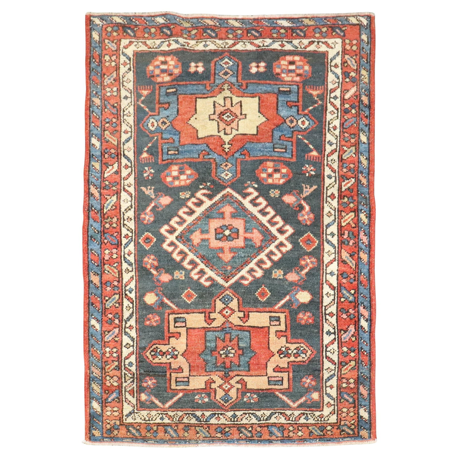 Early 20th Century Persian Heriz Wool Throw Rug 34 x 49 Inches: Early 20th Century Persian Heriz Wool Throw Rug 34 x 49 Inches This is a small antique Persian Heriz throw rug from the early 20th century. Hand-woven with wool, it features a rustic style and origina