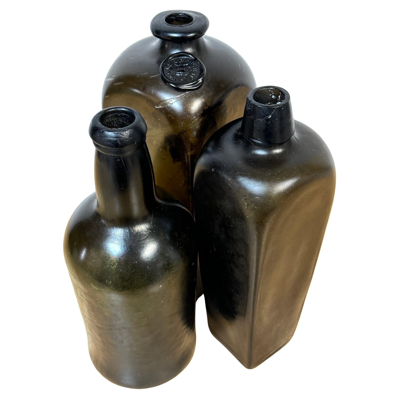 Set of 3 19th Century Olive Green Glass Liquor Bottles Van Den Bergh & Co.: Set of 3 19th Century Olive Green Glass Liquor Bottles Van Den Bergh & Co. This exquisite set of three 19th-century shipwreck olive green glass liquor bottles offers a unique glimpse into maritime his