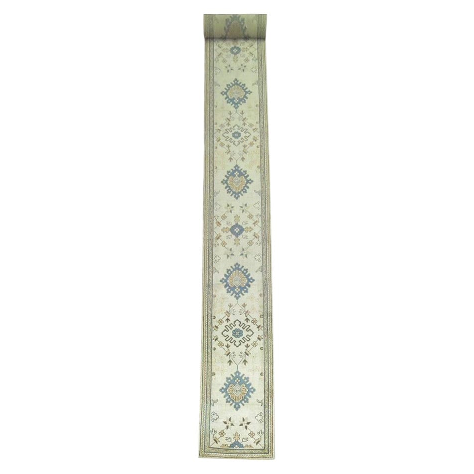 Rare Early 20th Century Hand-Woven Turkish Oushak Runner 27 x 268 in: Rare Early 20th Century Hand-Woven Turkish Oushak Runner 27 x 268 in This exquisite early 20th-century Oushak runner showcases a long and narrow design, measuring 27 in x 268 in. Hand-woven from high-