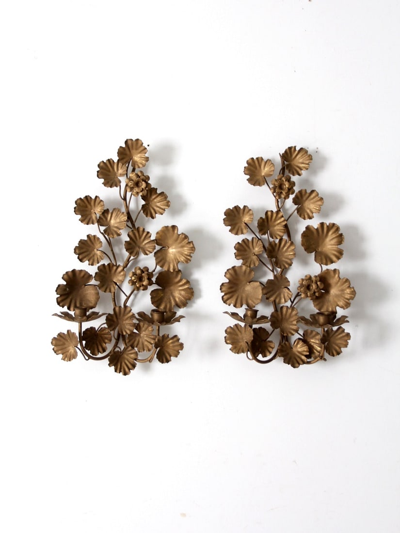 Pair of Mid Century Italian Gilt Tole Candle Sconces with Floral Design: Pair of Mid Century Italian Gilt Tole Candle Sconces with Floral Design Enhance your space with this exquisite pair of mid-century Italian tole candle sconces. Featuring beautifully crafted golden flo