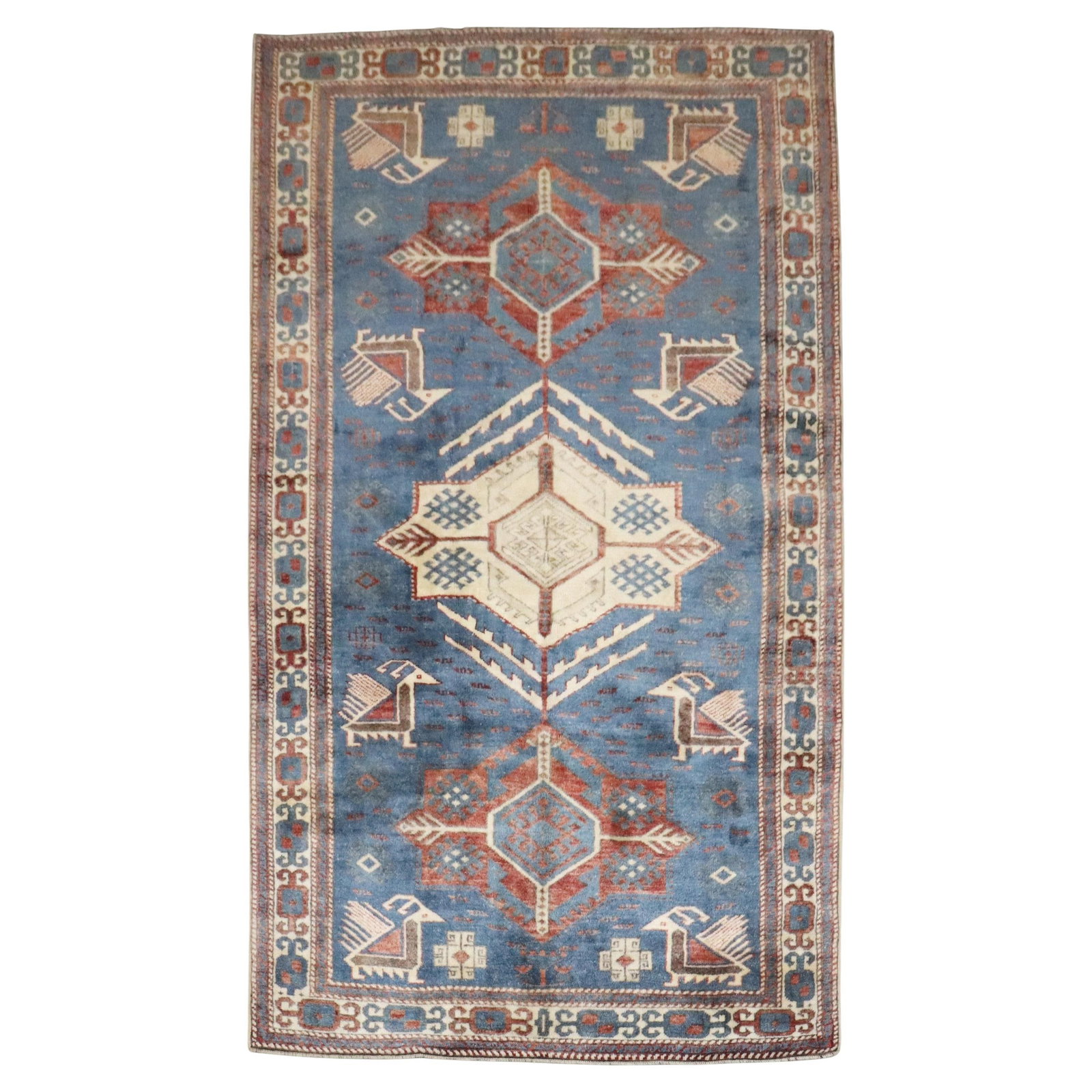 Late 20th Century Kazak Wool Rug Inspired by Caucasian Designs: Late 20th Century Kazak Wool Rug Inspired by Caucasian Designs This blue vintage-inspired Caucasian rug features a Kazak style and is hand-woven from wool. Originating from the Caucasus and crafted in