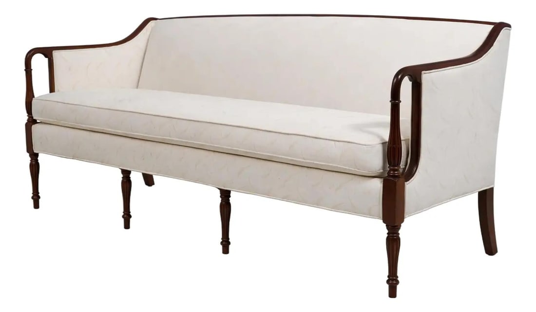 Sheraton Style Upholstered Sofa with Cherry Carved Details Georgian Court: Sheraton Style Upholstered Sofa with Cherry Carved Details Georgian Court This Ethan Allen Georgian Court upholstered sofa features fine carved cherry wood details and inlaid accents, embodying classi