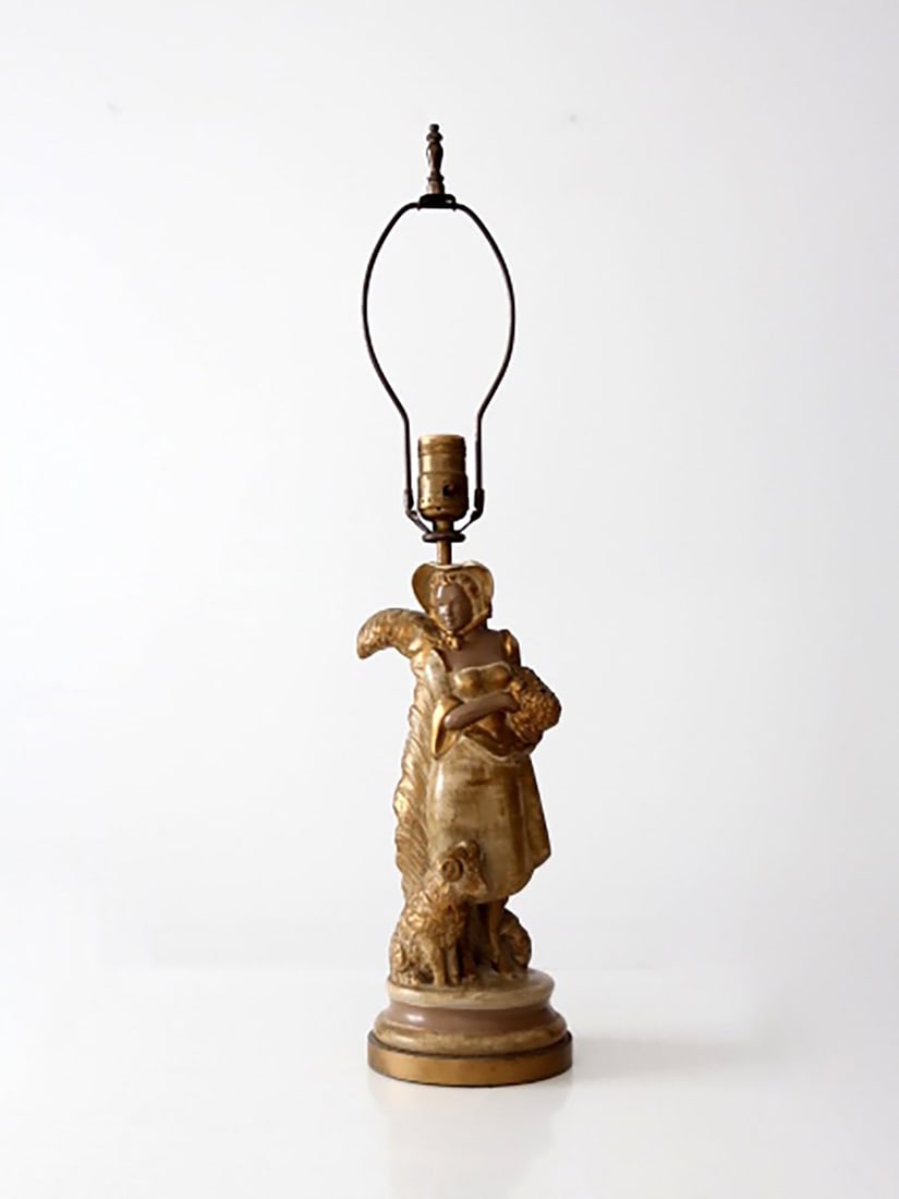 Early 20th Century Gilt Pastoral Figure Table Lamp with Sculptural Detail: Early 20th Century Gilt Pastoral Figure Table Lamp with Sculptural Detail This vintage table lamp showcases a sculptural pastoral figure with a warm gilt finish and softly modeled details, creating an