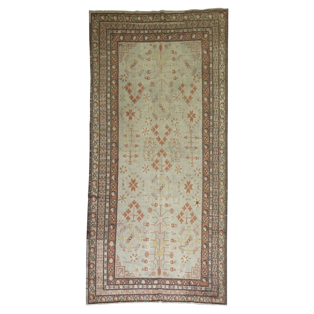 Early 20th Century Ivory Khotan Hand-Woven Wool Rug 5'9 x 11'6: Early 20th Century Ivory Khotan Hand-Woven Wool Rug 5'9 x 11'6 Discover this authentic early 20th century Khotan rug, a stunning piece that embodies the rich history of East Turkestan. This gallery-si