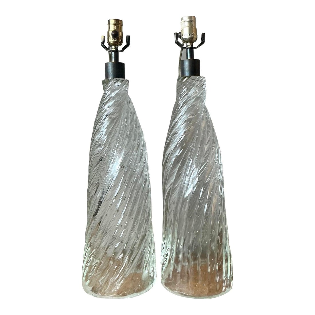 Pair of Twisted Clear Blown Glass Table Lamps with Brass Accents: Pair of Twisted Clear Blown Glass Table Lamps with Brass Accents This pair of vintage table lamps features elongated bodies crafted from clear, hand-blown optic glass with a distinctive continuous ver