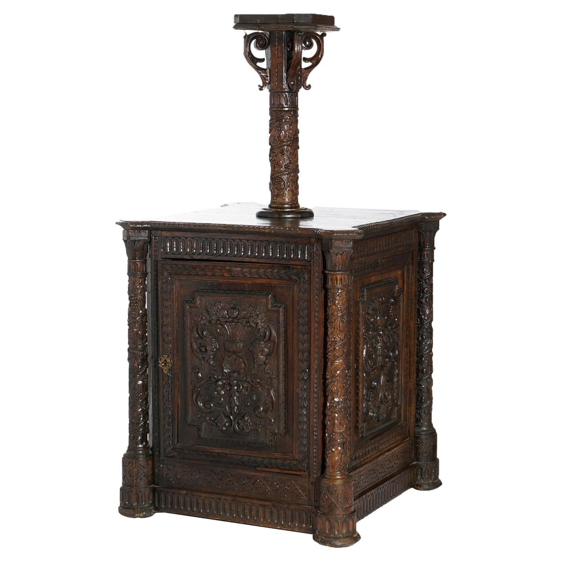 18th Century Carved Oak Continental Reliquary Cabinet with Columns: 18th Century Carved Oak Continental Reliquary Cabinet with Columns This exquisite 18th-century Continental reliquary cabinet is a remarkable example of antique craftsmanship, featuring a deeply carved
