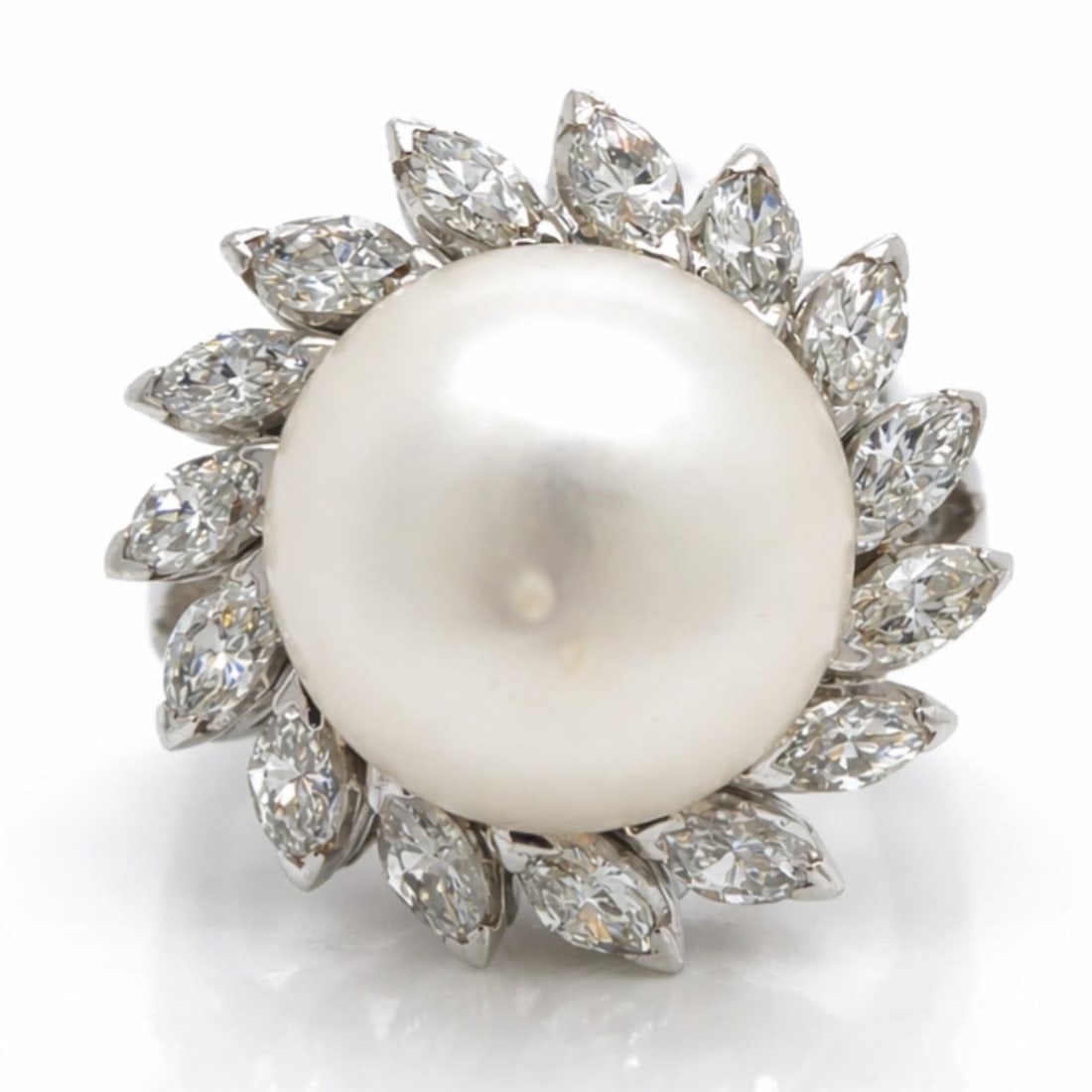 Platinum Ring with 12.1mm South Sea Pearl and Marquise Diamonds 1960s: Platinum Ring with 12.1mm South Sea Pearl and Marquise Diamonds 1960s This 1960s ring features a 12.1mm South Sea pearl set in platinum, complemented by 16 marquise diamonds totaling approximately 1.2