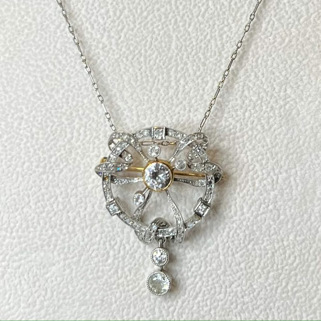 Art Deco Platinum 18K Diamond Pendant Brooch with 16 Inch Chain: Art Deco Platinum 18K Diamond Pendant Brooch with 16 Inch Chain This exquisite Art Deco pendant/brooch showcases a stunning combination of platinum and 18K gold, accented by brilliant diamonds. Weighi
