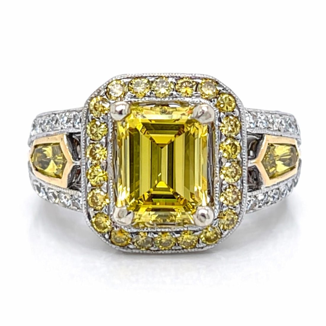 Emerald Cut Fancy Intense Yellow Diamond Ring in 18K White Gold Size 6.5: Emerald Cut Fancy Intense Yellow Diamond Ring in 18K White Gold Size 6.5 This 18K white gold ring features a central emerald-cut fancy intense yellow diamond, approximately 2.25 carats with VVS clarit