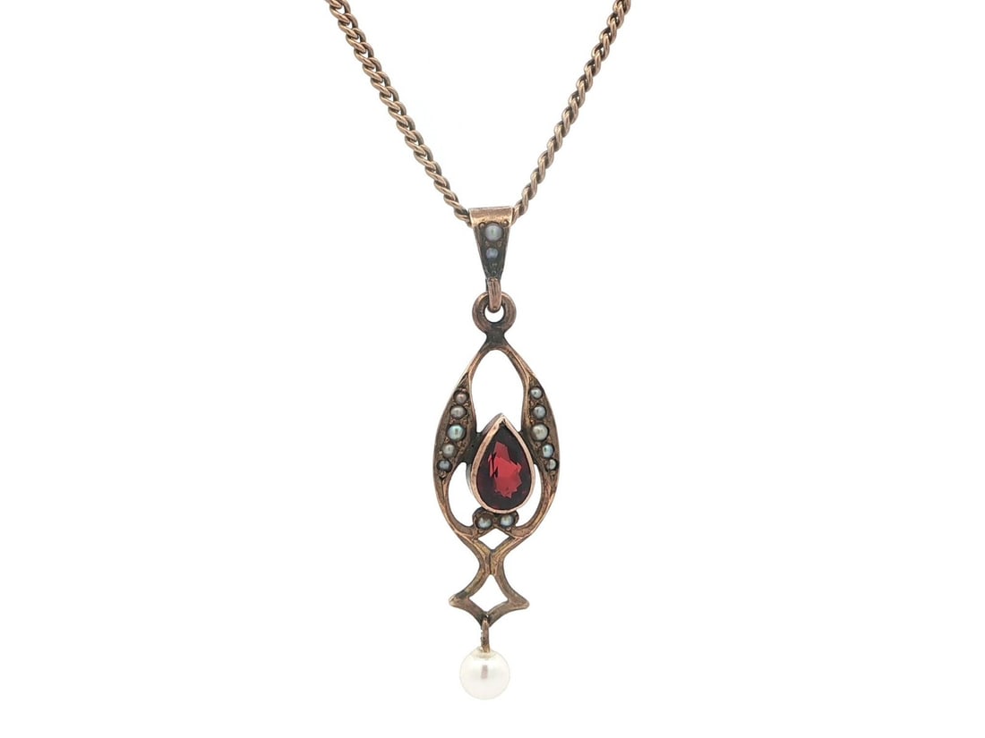 Victorian Era 10k Yellow Gold Garnet and Pearl Lavalier Necklace with Curb Chain: Victorian Era 10k Yellow Gold Garnet and Pearl Lavalier Necklace with Curb Chain This antique Victorian lavalier pendant necklace features a pear-cut natural brownish red garnet and genuine cultured s