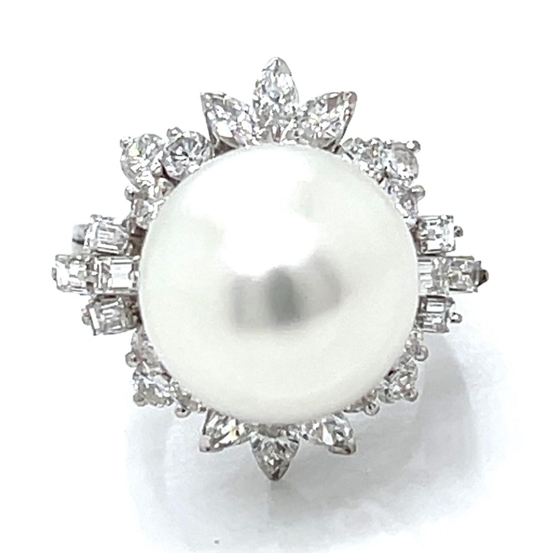 14K White Gold Ring with 13.3mm South Sea Pearl and 26 Diamonds Circa 1960s: 14K White Gold Ring with 13.3mm South Sea Pearl and 26 Diamonds Circa 1960s This 1960s ring features a 13.3mm South Sea pearl set in 14K white gold, accented by 26 diamonds with an approximate total w