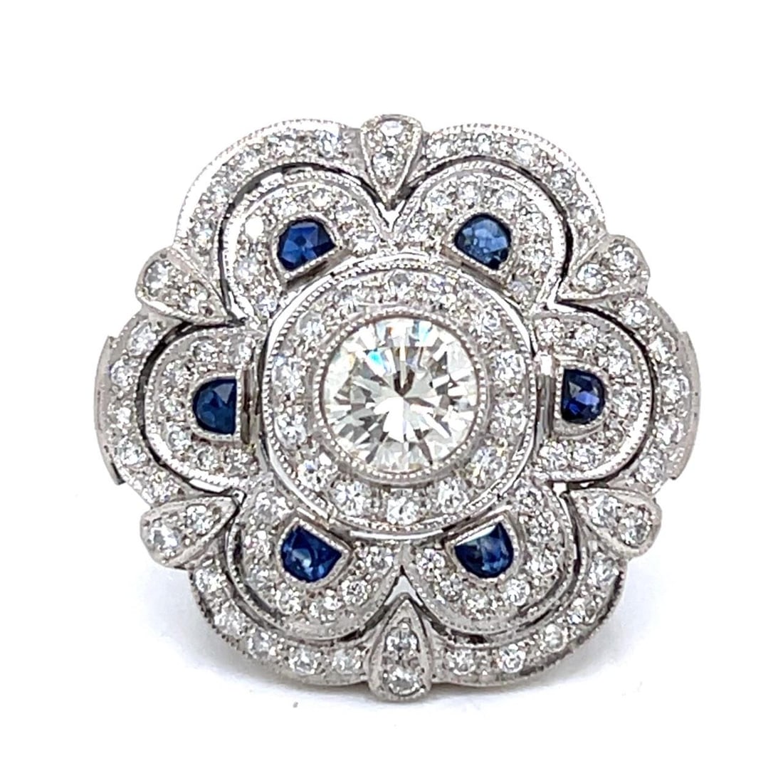 Platinum Ring with 1.25 Ct Diamond and Sapphires: Platinum Ring with 1.25 Ct Diamond and Sapphires This exquisite Platinum Diamond & Sapphire Ring features a stunning central diamond weighing approximately 1.25 Ct., showcasing K-L color and VVS clari