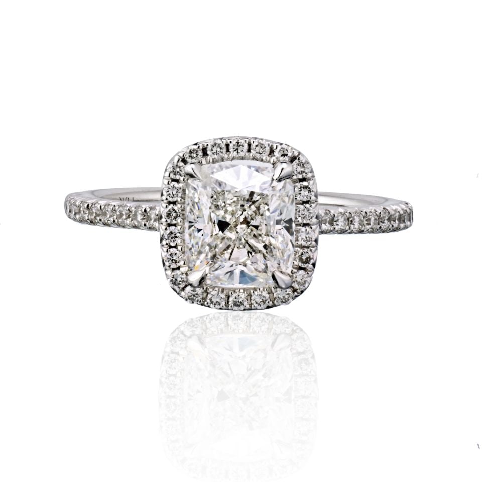 1.68 Carat GIA Cushion Cut Diamond Halo Engagement Ring in 18K White Gold: 1.68 Carat GIA Cushion Cut Diamond Halo Engagement Ring in 18K White Gold This exquisite engagement ring features a stunning 1.68 carat cushion cut diamond with a colorless grade of F and VS1 clarity,