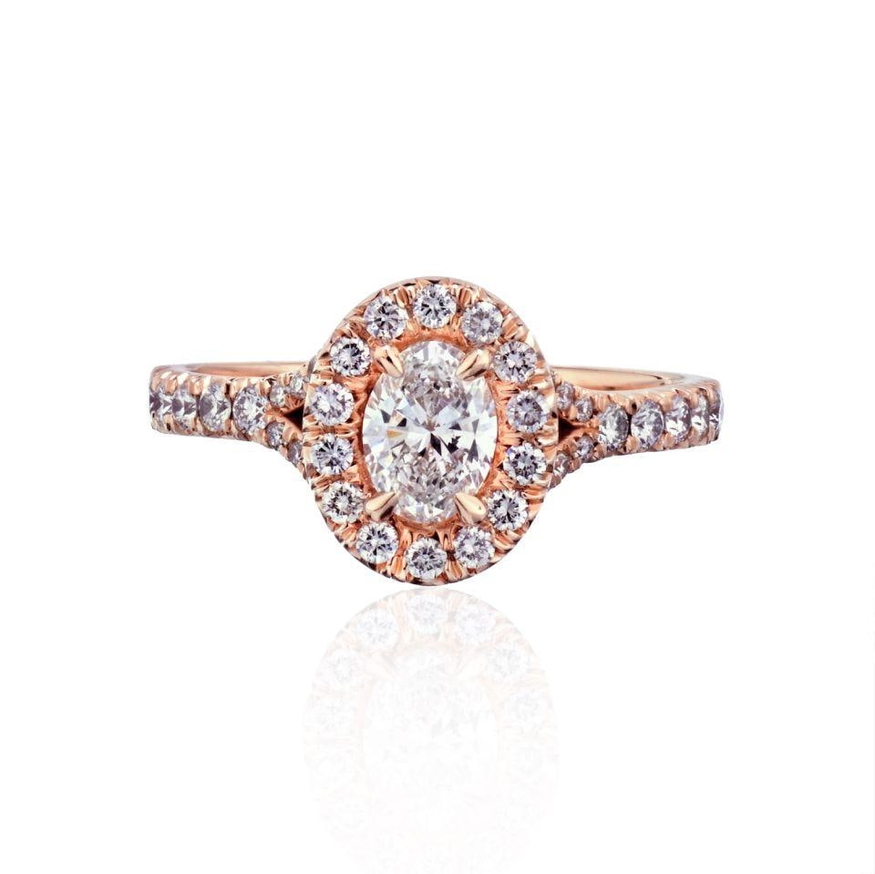 Rose Gold Oval 0.54ct D VS2 Diamond Halo GIA Engagement Ring: Rose Gold Oval 0.54ct D VS2 Diamond Halo GIA Engagement Ring This pre-owned ring features a 0.54 carat oval diamond with D color and VS2 clarity, certified by GIA. The setting is crafted from 14K rose