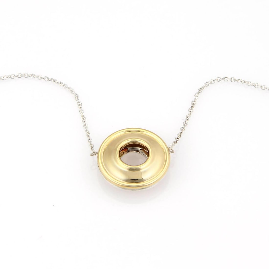 Tiffany & Co. Paloma Picasso Reversible Saucer Pendant Necklace in Silver & Gold: Tiffany & Co. Paloma Picasso Reversible Saucer Pendant Necklace in Silver & Gold This exquisite Tiffany & Co. necklace features a unique saucer-shaped pendant crafted from sterling silver and 18k yell