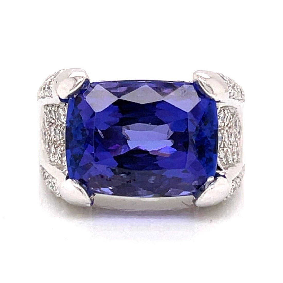 Tanzanite and Diamond Ring in 18K White Gold with 13 Ct Gemstone: Tanzanite and Diamond Ring in 18K White Gold with 13 Ct Gemstone This pre-owned ring features a striking 13.00 carat tanzanite set in 18K white gold, accented by 82 diamonds with a total weight of app
