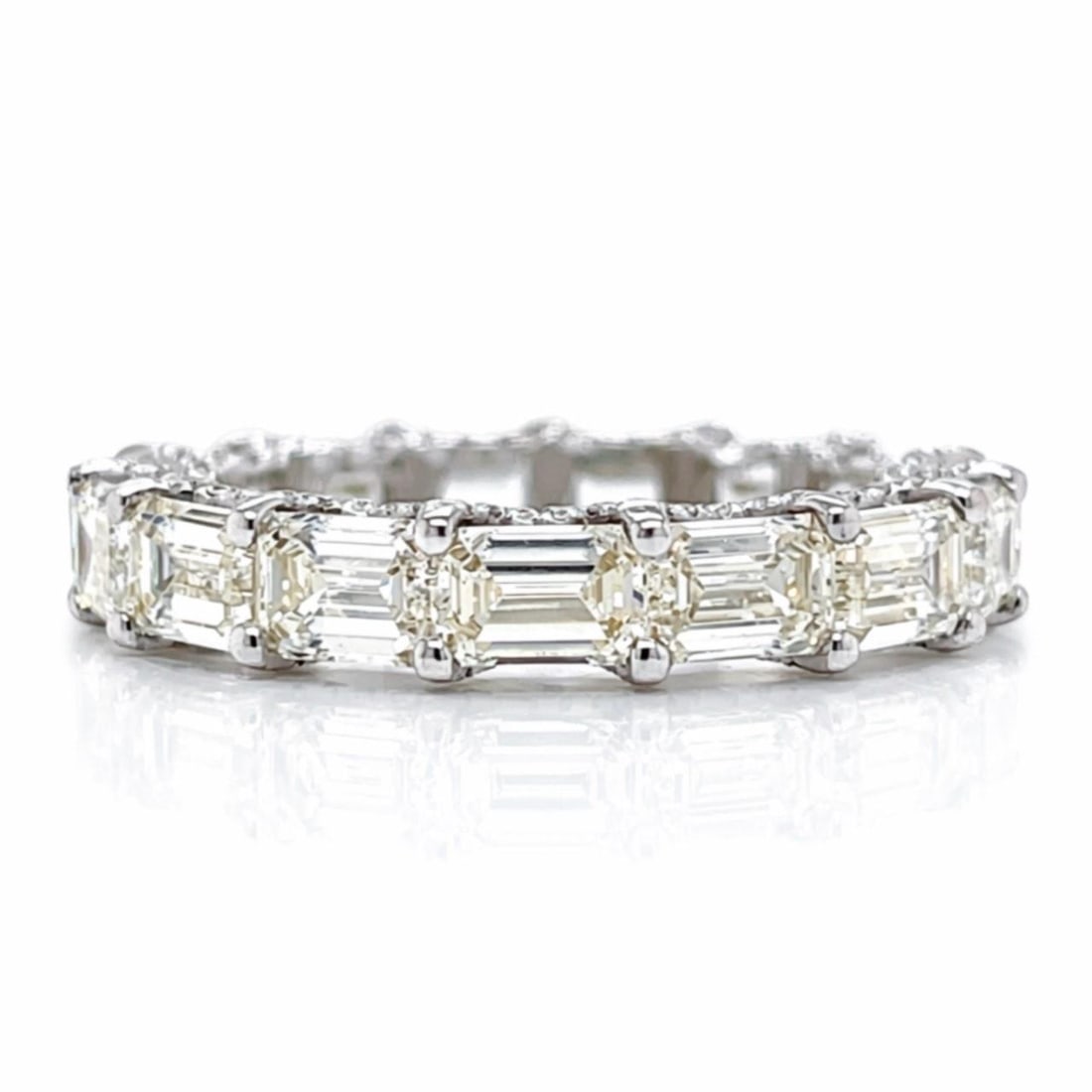 Men's Eternity Ring in 18K White Gold with 11.50 Ct Emerald Cut Diamonds: Men's Eternity Ring in 18K White Gold with 11.50 Ct Emerald Cut Diamonds This men's eternity band features 15 emerald-cut diamonds with a total weight of approximately 11.50 carats, displaying J-K col