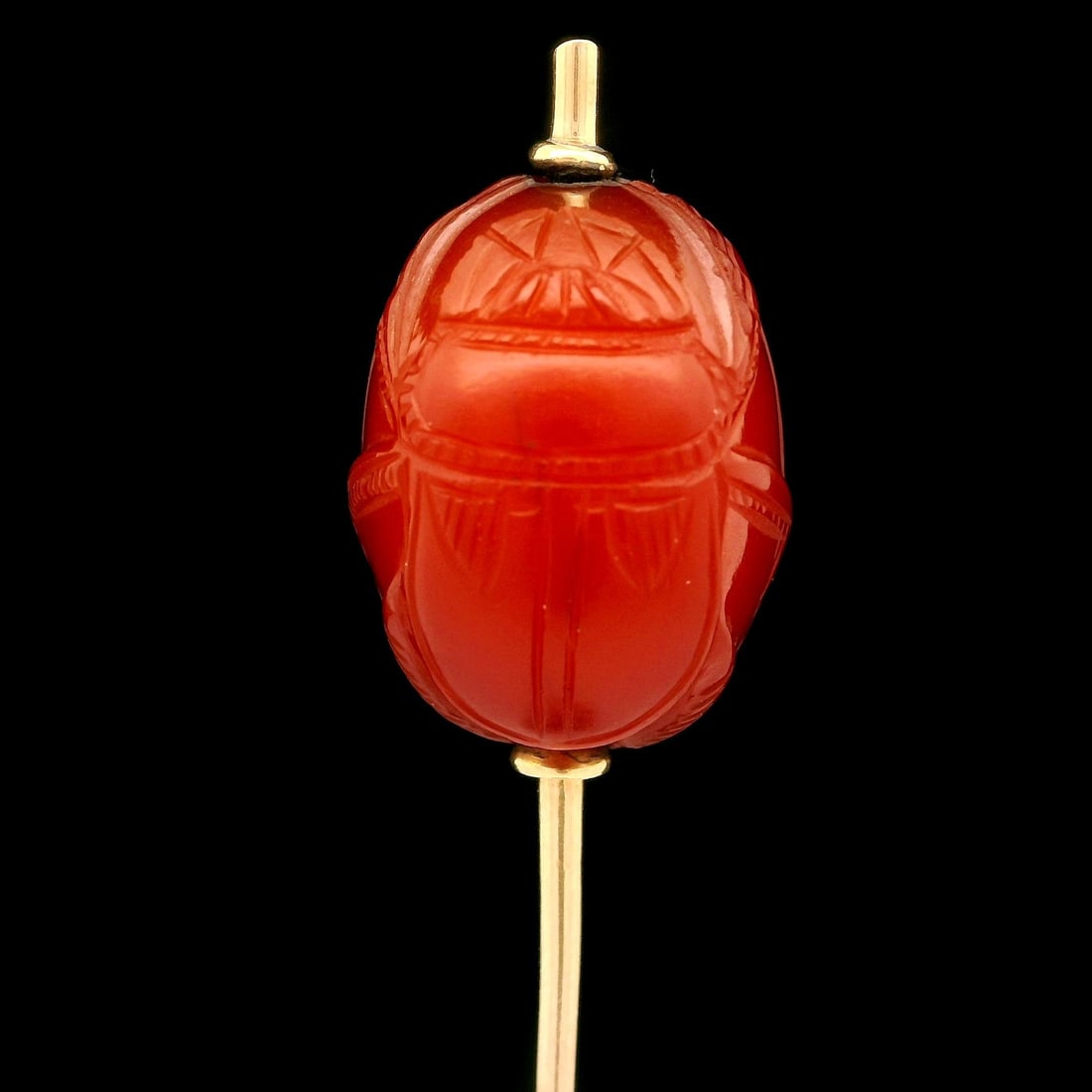 Antique Egyptian Revival 18k Gold Carved Scarab Carnelian Stick Pin: Antique Egyptian Revival 18k Gold Carved Scarab Carnelian Stick Pin Discover the elegance of this Antique Egyptian Revival stick pin, crafted in 18k yellow gold. The pin features a beautifully carved 