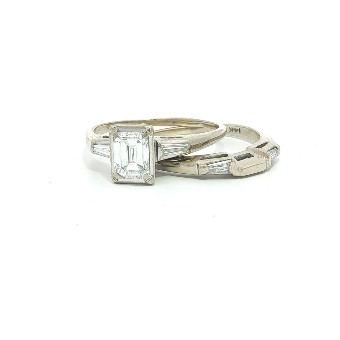 White Gold Engagement and Wedding Ring Set with Emerald Cut and Baguette Diamonds: White Gold Engagement and Wedding Ring Set with Emerald Cut and Baguette Diamonds This vintage engagement ring and wedding band set features a natural emerald-cut diamond as the centerpiece, accented 