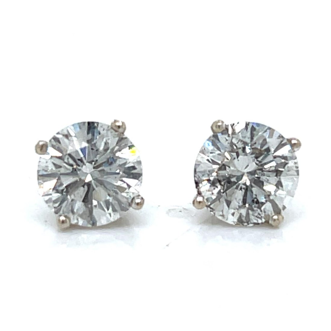 Diamond Stud Earrings in 14K White Gold 3.26 Carat Total Weight: Diamond Stud Earrings in 14K White Gold 3.26 Carat Total Weight These 14K white gold stud earrings feature two diamonds with a total weight of 3.26 carats. The diamonds are graded G-H in color and SI2
