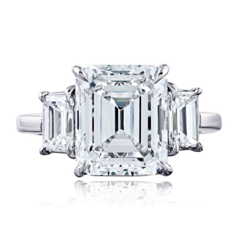 Platinum Three Stone Engagement Ring 5.18ct F SI1 GIA Emerald Cut Diamond: Platinum Three Stone Engagement Ring 5.18ct F SI1 GIA Emerald Cut Diamond This platinum engagement ring features a 5.18 carat emerald cut diamond at its center, certified by GIA with F color and SI1 c