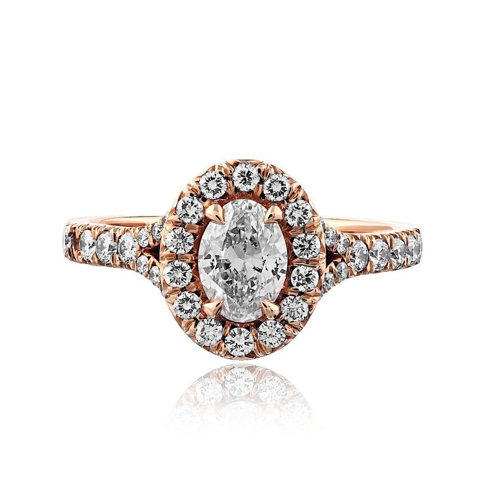 Oval 0.55ct F SI2 Diamond Engagement Ring with 36 Round Accents in 14K Rose Gold: Oval 0.55ct F SI2 Diamond Engagement Ring with 36 Round Accents in 14K Rose Gold This pre-owned ring features a 0.55 carat oval diamond with F color and SI2 clarity, set in 14K rose gold. The design i