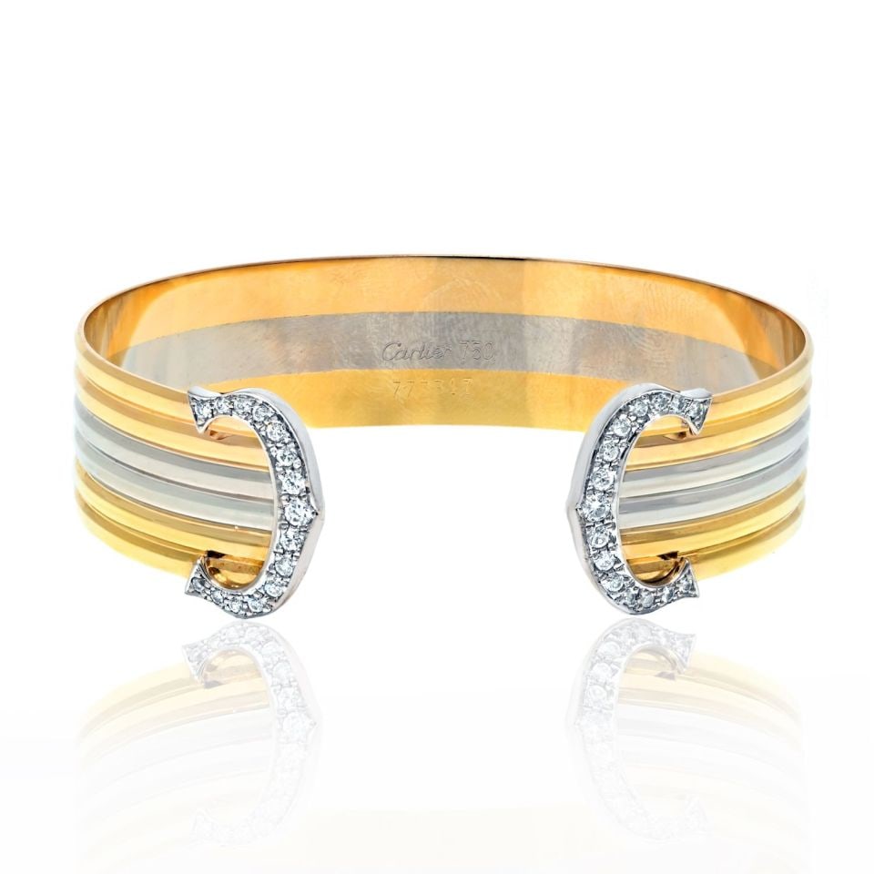 Cartier 18K Tri Color Diamond Cuff Bracelet from C de Cartier: Cartier 18K Tri Color Diamond Cuff Bracelet from C de Cartier This exquisite Cartier 18K Tri Color Double C Diamond Open Cuff Bracelet is a stunning piece from the prestigious C de Cartier collection,