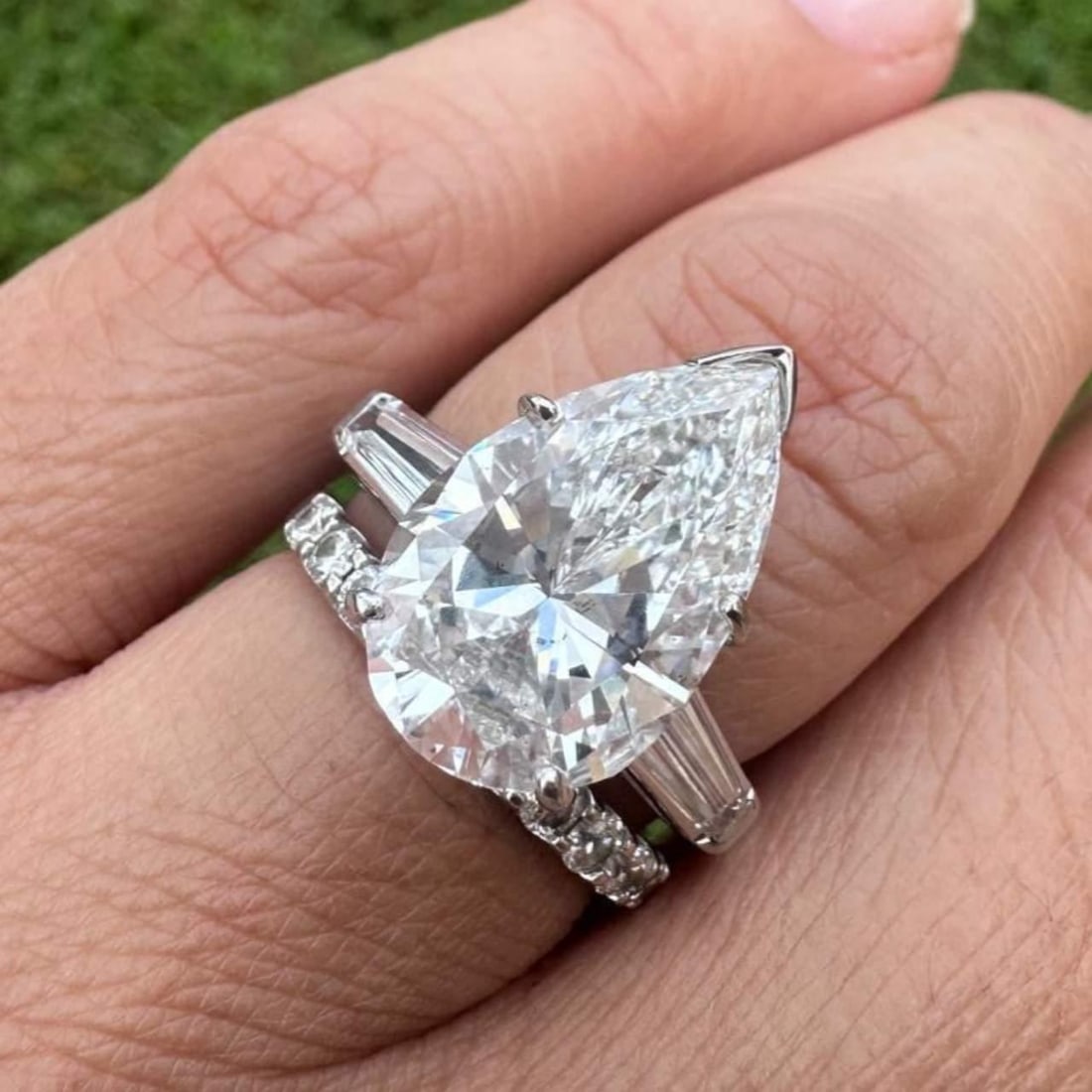 Platinum GIA Certified 7.29 Ct Pear Diamond Ring with Baguette Accents: Platinum GIA Certified 7.29 Ct Pear Diamond Ring with Baguette Accents This stunning platinum ring features a GIA Certified 7.29 Ct. pear-shaped diamond, showcasing exceptional brilliance. The diamond
