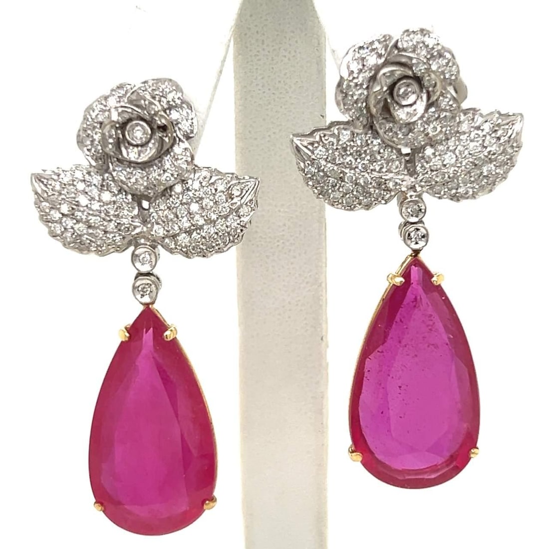 18K White Gold Ruby Diamond Earrings 30Ct Rubies 2.5Ct Diamonds: 18K White Gold Ruby Diamond Earrings 30Ct Rubies 2.5Ct Diamonds These exquisite 18K white gold earrings feature stunning pear-shaped rubies and a dazzling array of diamonds. Each earring is set with 2