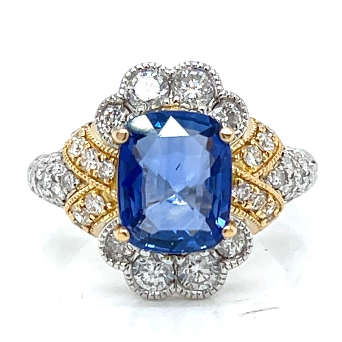 Sapphire and Diamond Ring in 18K White and Yellow Gold with 3.13 Ct Sapphire: Sapphire and Diamond Ring in 18K White and Yellow Gold with 3.13 Ct Sapphire This pre-owned ring features an elegant design crafted from 18K white and yellow gold. It is set with a 3.13 carat sapphire