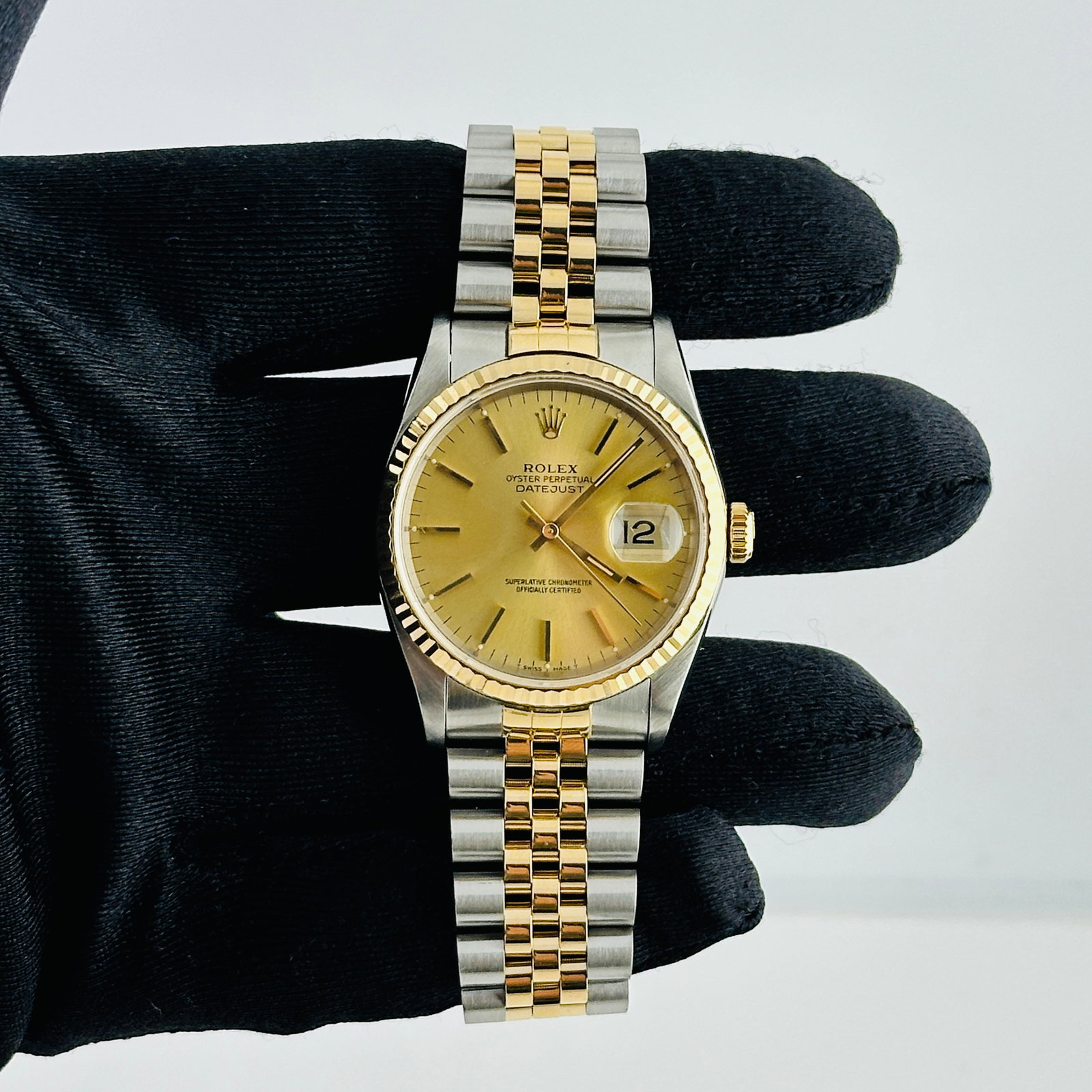 Rolex Datejust 16233 Champagne Stick Dial Jubilee Bracelet Papers 1991: Rolex Datejust 16233 Champagne Stick Dial Jubilee Bracelet Papers 1991 This Rolex Datejust watch features a champagne stick dial and a fluted bezel, complemented by a D-Link Jubilee bracelet. It is a 