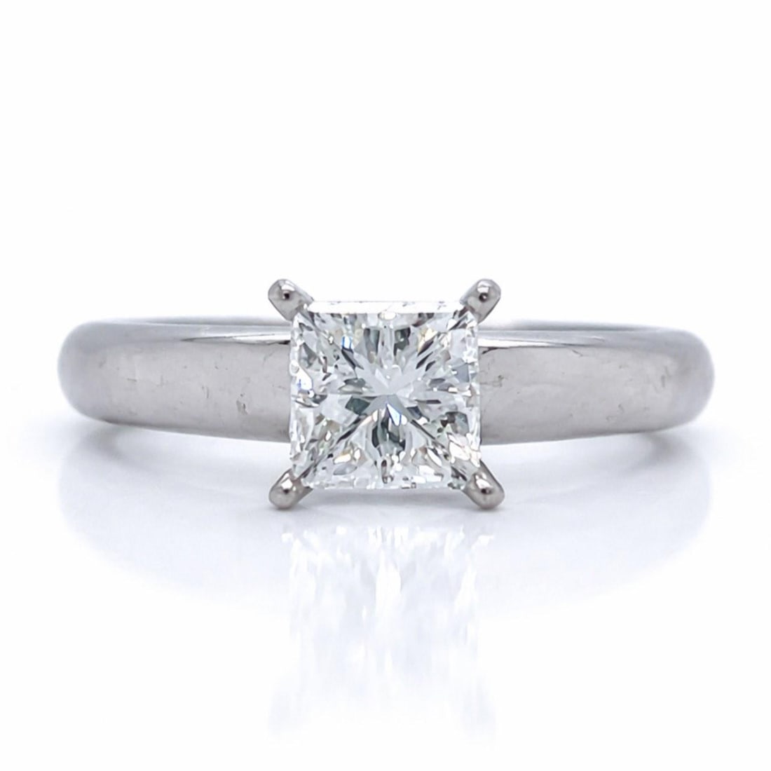 18K White Gold Princess Cut Diamond Ring 1.02 Carat Size 5.5: 18K White Gold Princess Cut Diamond Ring 1.02 Carat Size 5.5 This 18K white gold ring features a 1.02 carat princess-cut diamond with F color and VS2 clarity. The ring weighs 5.6 grams and is a size 5