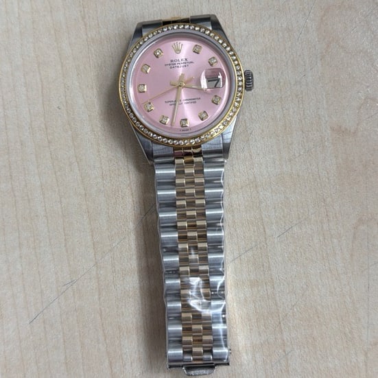 Datejust Ref 1601 Mens Watch With Aftermarket Pink Diamond Dial: Datejust Ref 1601 Mens Watch With Aftermarket Pink Diamond Dial This Rolex Datejust features an aftermarket pink diamond dial and a pave plated diamond bezel. The watch is designed for men and is equi