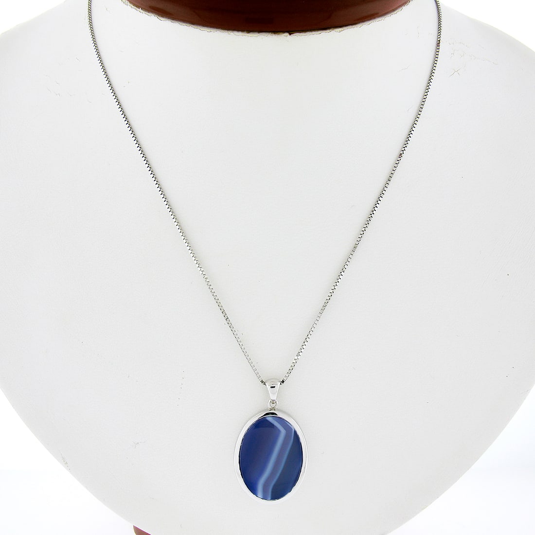 14k White Gold Oval Blue Agate Pendant Necklace 20 inch Chain: 14k White Gold Oval Blue Agate Pendant Necklace 20 inch Chain This stunning 14k white gold pendant showcases an elegant oval blue banded agate, perfectly complemented by a 20-inch box link chain. The 