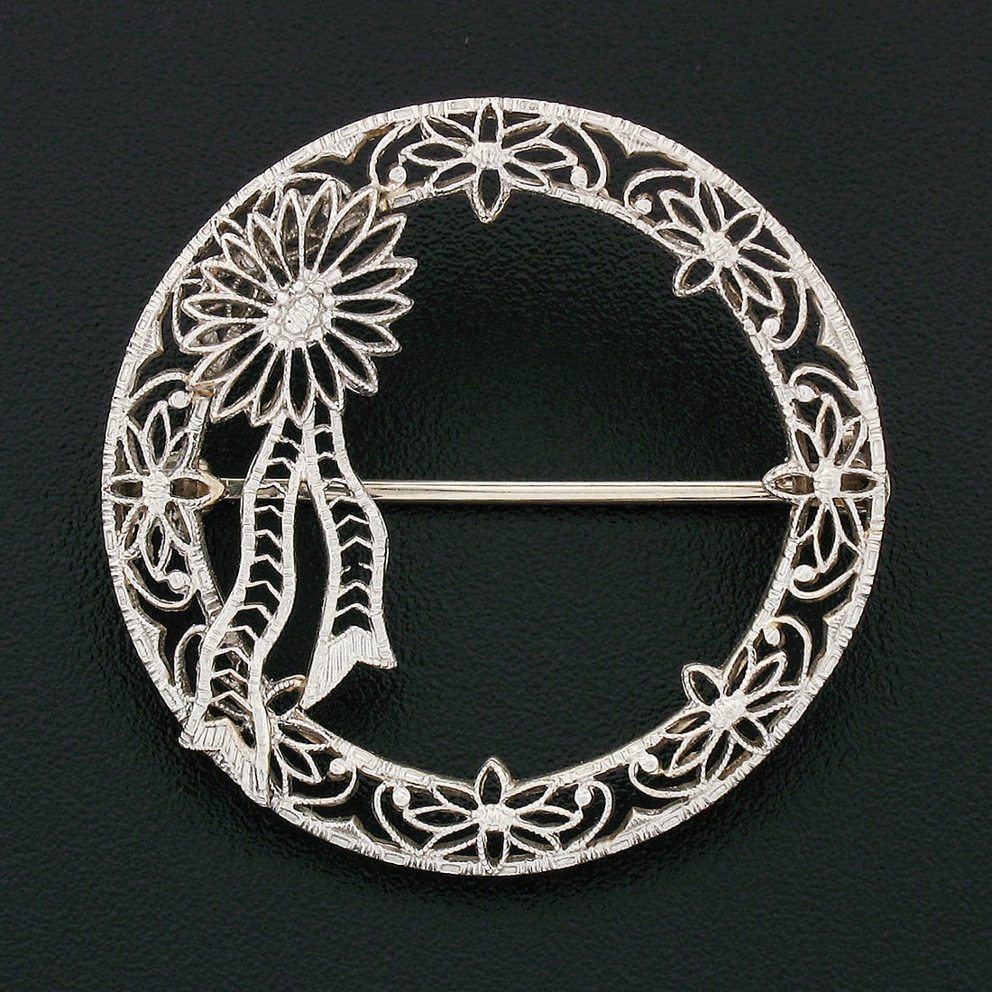 Antique Art Deco 14k White Gold Filigree Floral Ribbon Brooch Pin: Antique Art Deco 14k White Gold Filigree Floral Ribbon Brooch Pin This exquisite Antique Art Deco brooch is crafted from solid 14k white gold, showcasing a stunning open circle wreath design embellish