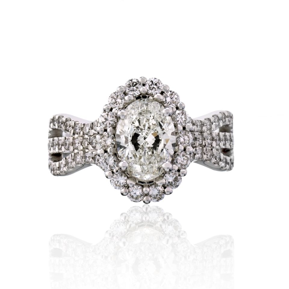 1.50 Carat GIA Oval Diamond Engagement Ring in 14K White Gold: 1.50 Carat GIA Oval Diamond Engagement Ring in 14K White Gold This exquisite engagement ring features a stunning 1.50 carat oval diamond, graded I/I1 by GIA, elegantly set in a halo of round diamonds 
