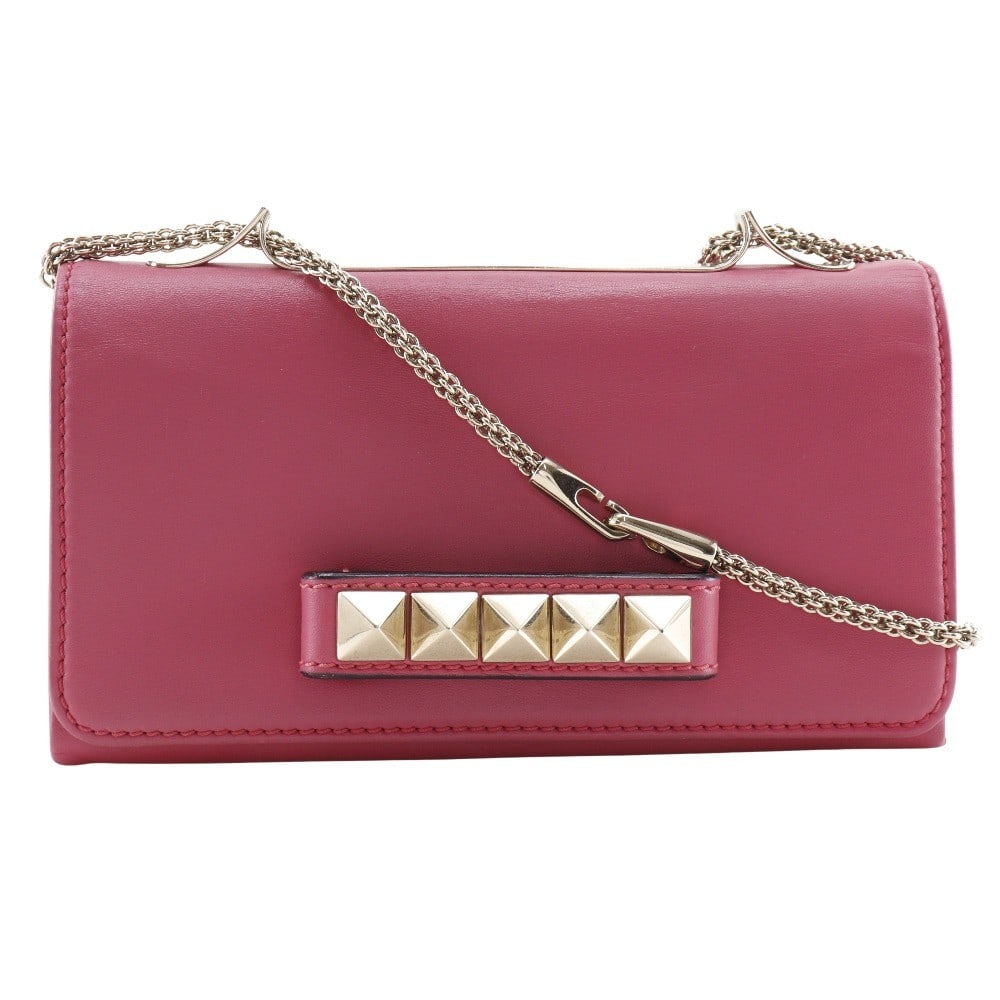 Va Va Voom Pink Leather Clutch by Valentino Garavani: Va Va Voom Pink Leather Clutch by Valentino Garavani This Valentino Garavani Va Va Voom clutch is crafted from pink leather and designed for women. It features a structured silhouette with Italian cra