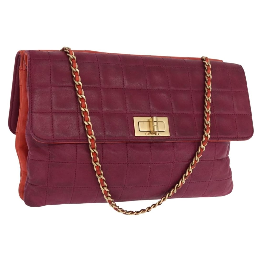 Orange Lambskin Choco Bar Handbag by CHANEL with Gold CC Logo: Orange Lambskin Choco Bar Handbag by CHANEL with Gold CC Logo This CHANEL Choco Bar handbag is crafted from soft lambskin leather in a striking orange and gold color combination. Made in Italy, it fea