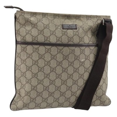 Gucci GG Supreme Beige Silver Shoulder Bag PVC Leather: Gucci GG Supreme Beige Silver Shoulder Bag PVC Leather This GUCCI GG Supreme shoulder bag features a beige and silver color scheme and is crafted from PVC leather and GG canvas. Designed with an adjus