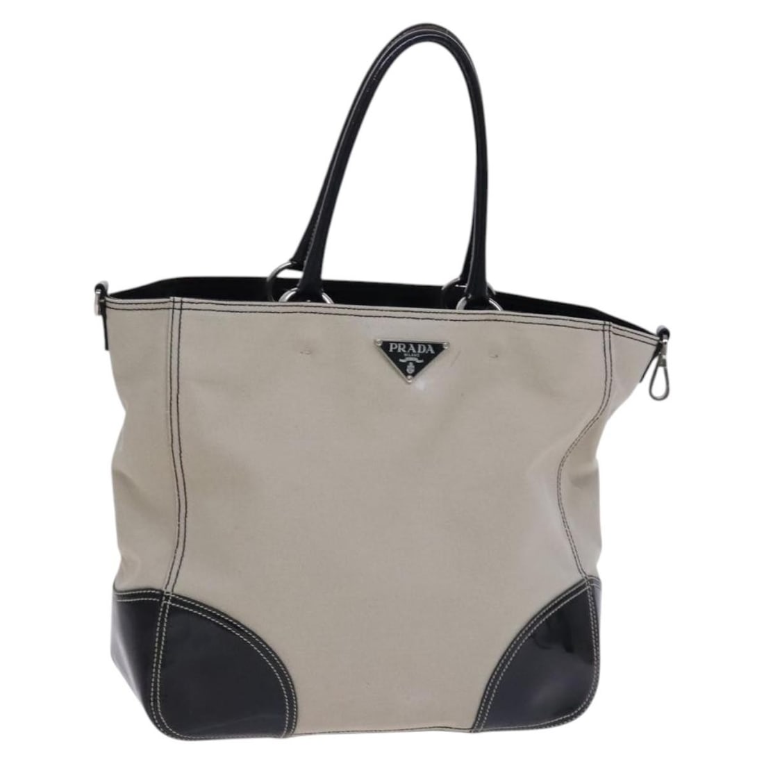 Beige Canvas Tote by PRADA with Guarantee Card: Beige Canvas Tote by PRADA with Guarantee Card This PRADA tote bag features a beige canvas exterior and is designed for women. The bag includes a guarantee card as an accessory and was made in Italy. 