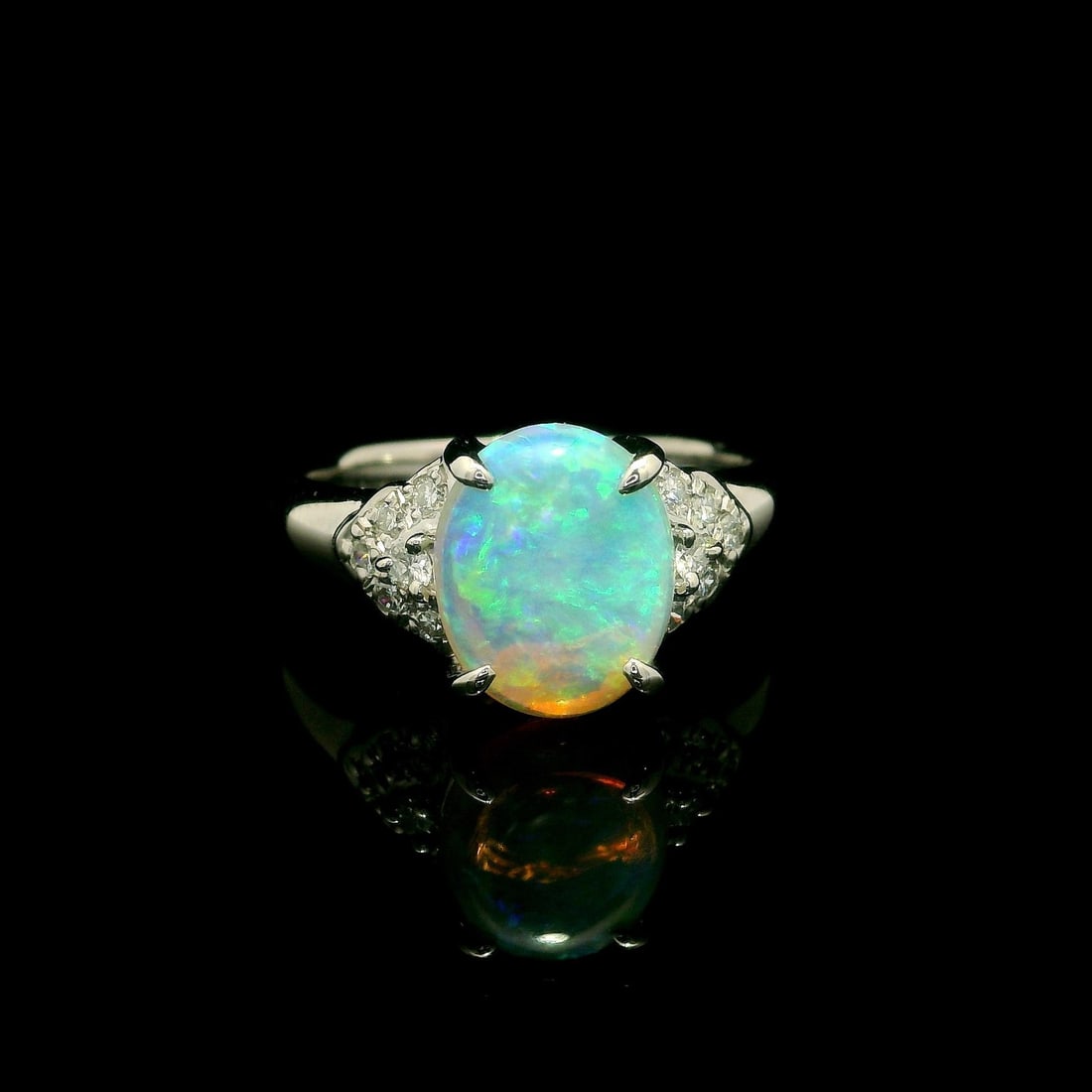 Classic Solid Platinum 1.65ctw Oval Opal Ring with Diamond Accents: Classic Solid Platinum 1.65ctw Oval Opal Ring with Diamond Accents This exquisite cocktail ring features a stunning natural genuine opal in an oval cabochon cut, showcasing a fiery play of colors. The