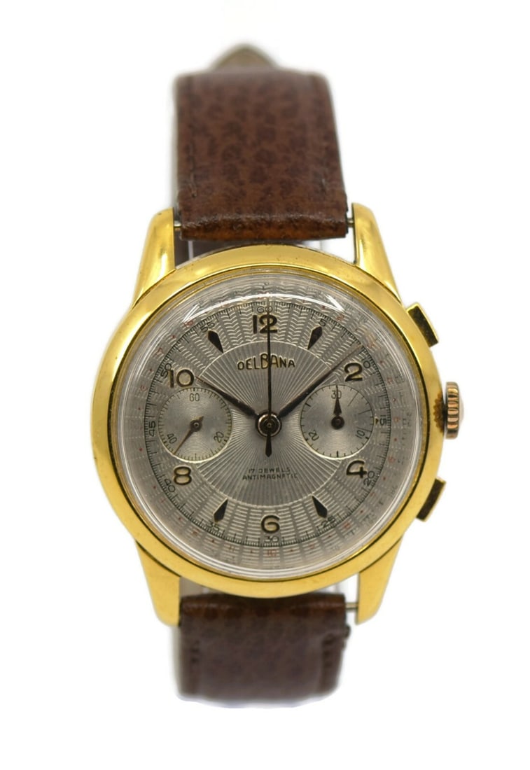 Delbana Vintage Two Tone Chronograph Mechanical Watch: Delbana Vintage Two Tone Chronograph Mechanical Watch This Delbana Vintage Chronograph wristwatch showcases a beautiful antique vintage style. The watch features a striking silver dial complemented by