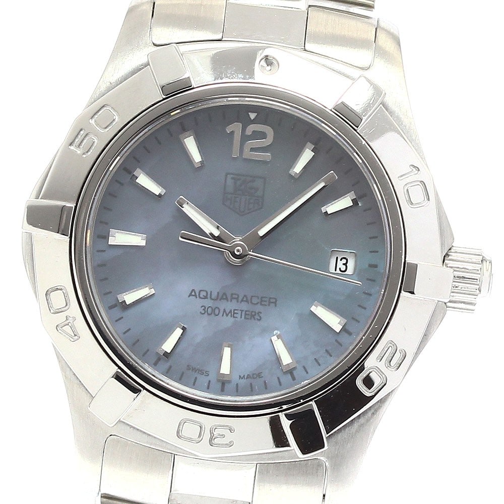 TAG Heuer Aquaracer WAF1417 Quartz Ladies Date Watch: TAG Heuer Aquaracer WAF1417 Quartz Ladies Date Watch This TAG Heuer Aquaracer WAF1417 is a pre-owned women's wristwatch featuring a stainless steel case and band with a blue shell dial. The quartz mov