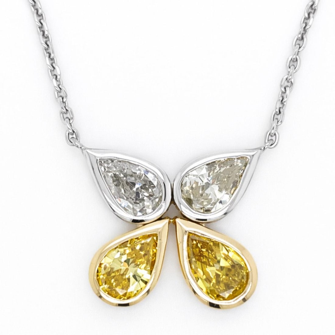 Diamond Pendant with Fancy Yellow Pear Diamonds on 14K White Gold Chain: Diamond Pendant with Fancy Yellow Pear Diamonds on 14K White Gold Chain This pendant features an 18K yellow and white gold setting adorned with two irradiated fancy intense yellow pear-shape diamonds 