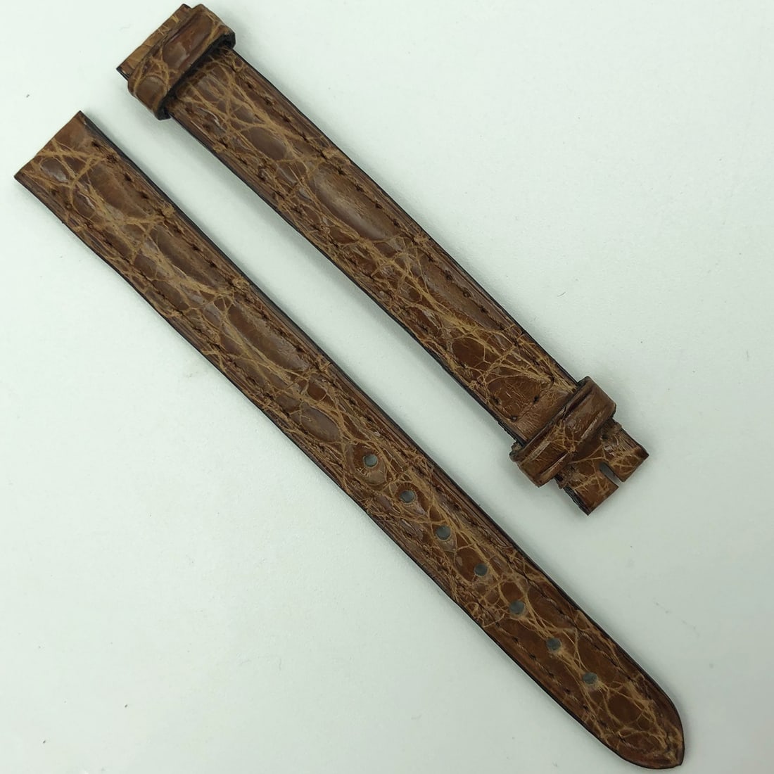 Cartier 11mm Light Brown Leather Watch Band 1AGBAC14: Cartier 11mm Light Brown Leather Watch Band 1AGBAC14 This authentic Cartier wristwatch band is crafted from light brown leather, measuring 11mm in width, making it a stylish replacement for your timep